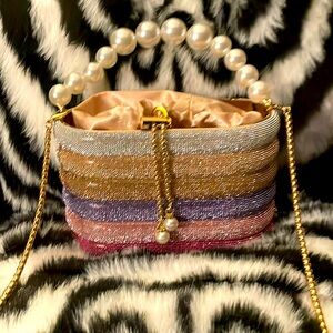 Rainbow rhinestone bucket bag with pearl and gold chain handles and satin lining
